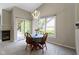 Dining area with sliding glass doors to the backyard and a view of the fireplace at 7335 Pymbroke Dr, Fishers, IN 46038