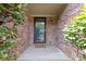 Inviting entryway with brick walls, a glass door, and a welcoming mat at 7335 Pymbroke Dr, Fishers, IN 46038