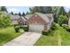 Charming brick home featuring manicured landscaping and an attached two car garage at 7335 Pymbroke Dr, Fishers, IN 46038