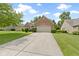 Charming brick home featuring manicured landscaping and a two-car garage at 7335 Pymbroke Dr, Fishers, IN 46038