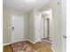 Well-lit hallway featuring hardwood floors and neutral walls at 7335 Pymbroke Dr, Fishers, IN 46038