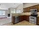 Open kitchen with stainless steel appliances and granite counters flows into the dining and living areas at 7335 Pymbroke Dr, Fishers, IN 46038