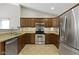 Well-lit kitchen with stainless steel appliances, tile flooring, and ample counter space at 7335 Pymbroke Dr, Fishers, IN 46038
