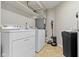 Functional laundry room with washer, dryer, storage shelves and water softener at 7335 Pymbroke Dr, Fishers, IN 46038
