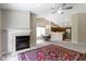 Bright living room features fireplace, vaulted ceilings, and seamless flow to the kitchen and dining area at 7335 Pymbroke Dr, Fishers, IN 46038