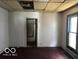 Empty bedroom needing renovation with damaged walls and an interior view to bathroom at 811 W 25Th St, Indianapolis, IN 46208