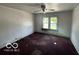Empty bedroom with peeling paint and carpet, showcasing potential for renovation at 811 W 25Th St, Indianapolis, IN 46208