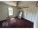 Bedroom with damaged walls and a window, needing extensive renovation at 811 W 25Th St, Indianapolis, IN 46208