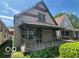 Modest two-story home featuring a covered front porch and neutral siding at 811 W 25Th St, Indianapolis, IN 46208