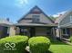Modest two-story home featuring a covered front porch and neutral siding at 811 W 25Th St, Indianapolis, IN 46208