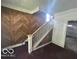 Foyer with staircase, damaged walls, and access to other rooms at 811 W 25Th St, Indianapolis, IN 46208