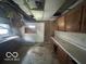 Outdated kitchen with damaged walls and ceilings, requiring extensive renovation at 811 W 25Th St, Indianapolis, IN 46208