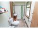Compact bathroom featuring a charming vanity, patterned shower curtain, and natural light at 829 Waldemere Ave, Indianapolis, IN 46241