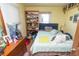 Bright bedroom with a bed, dresser, and window, showcasing a comfortable and personal space at 829 Waldemere Ave, Indianapolis, IN 46241