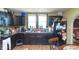 Functional kitchen with dark cabinetry, black appliances, and a view of the window at 829 Waldemere Ave, Indianapolis, IN 46241