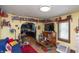 Cozy living room with hardwood floors, custom shelving, and an open layout to the kitchen at 829 Waldemere Ave, Indianapolis, IN 46241