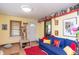 Bright living room with a plush blue sofa, red rug, and a view of the front door at 829 Waldemere Ave, Indianapolis, IN 46241