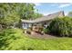 Expansive backyard featuring a deck, sunroom, and custom wooden planting boxes at 8330 Claridge Rd, Indianapolis, IN 46260
