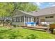 Manicured backyard featuring a pond, a deck and multiple seating areas, perfect for outdoor entertaining at 8330 Claridge Rd, Indianapolis, IN 46260