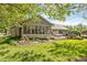 Beautiful backyard with a large deck, lush lawn, and established landscaping at 8330 Claridge Rd, Indianapolis, IN 46260