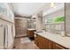 Modern bathroom with dual sinks, floating vanity, quartz countertop, and walk-in shower at 8330 Claridge Rd, Indianapolis, IN 46260