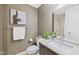 Bathroom featuring a granite countertop, framed mirror, and a shower behind the toilet at 8330 Claridge Rd, Indianapolis, IN 46260