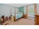 Charming bedroom with a canopy bed, colorful curtains and a decorative accent wall at 8330 Claridge Rd, Indianapolis, IN 46260