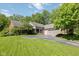 Charming brick home featuring an attached two-car garage and a well-manicured front lawn at 8330 Claridge Rd, Indianapolis, IN 46260