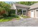 A cozy home exterior featuring a covered porch, lush ivy, and a driveway with ample parking at 8330 Claridge Rd, Indianapolis, IN 46260