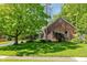 A brick home with a star decoration and a well-kept lawn provides classic curb appeal at 8330 Claridge Rd, Indianapolis, IN 46260