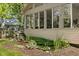 Charming sunroom exterior with serene water feature and lush landscaping at 8330 Claridge Rd, Indianapolis, IN 46260