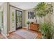 A well-lit foyer with hardwood floors, a decorative rug, and a stylish mirror above an antique cabinet at 8330 Claridge Rd, Indianapolis, IN 46260