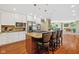 Modern kitchen with a large island, white cabinetry, and stainless steel appliances is open to the dining area at 8330 Claridge Rd, Indianapolis, IN 46260