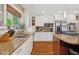 Well-lit kitchen showcasing granite countertops, stainless steel appliances, and ample cabinet space with window view at 8330 Claridge Rd, Indianapolis, IN 46260