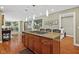 Open-concept kitchen features a granite island with bar seating and a gas cooktop in a bright and spacious setting at 8330 Claridge Rd, Indianapolis, IN 46260