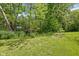 Lush green outdoor space with mature trees and a natural walking path at 8330 Claridge Rd, Indianapolis, IN 46260