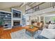 Open-concept living space with fireplace, built-ins, views to the kitchen, and hardwood floors under natural light at 8330 Claridge Rd, Indianapolis, IN 46260