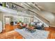 Open living room with second story, hardwood floors, comfortable seating and views into the dinning area at 8330 Claridge Rd, Indianapolis, IN 46260