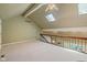 Bright loft area with railing, skylight, and neutral carpet providing an open and airy ambiance at 8330 Claridge Rd, Indianapolis, IN 46260