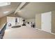 A versatile bonus room with high ceilings, skylights, and a ceiling fan at 8330 Claridge Rd, Indianapolis, IN 46260
