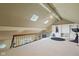 Upper loft area with skylights, ceiling fan and railing overlooking the lower level at 8330 Claridge Rd, Indianapolis, IN 46260