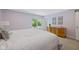 Light-filled bedroom with a dresser and sliding door access to the backyard at 8330 Claridge Rd, Indianapolis, IN 46260