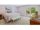 Serene bedroom with natural light, bench seat, and private patio access at 8330 Claridge Rd, Indianapolis, IN 46260
