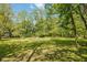 Large, open yard with a fire pit surrounded by seating at 8330 Claridge Rd, Indianapolis, IN 46260