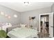Bedroom with light gray walls, cozy lighting, and a comfortable bed setup at 853 S Belleview Pl, Indianapolis, IN 46221