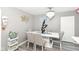 Elegant dining room with a white table, comfortable seating, and decorative wall mirrors at 853 S Belleview Pl, Indianapolis, IN 46221