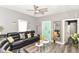 Bright living room with a comfortable black leather sofa and a stylish turquoise door at 853 S Belleview Pl, Indianapolis, IN 46221