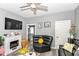 Comfortable living room with a fireplace, cozy seating, and a ceiling fan, ideal for relaxation and entertainment at 853 S Belleview Pl, Indianapolis, IN 46221