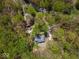 Scenic aerial shot showcases property with a house, cars, and tree-lined landscape at 8581 N Goat Hollow Rd, Mooresville, IN 46158