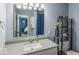Bathroom featuring single sink vanity with white countertop and blue walls plus views of bedroom at 8581 N Goat Hollow Rd, Mooresville, IN 46158